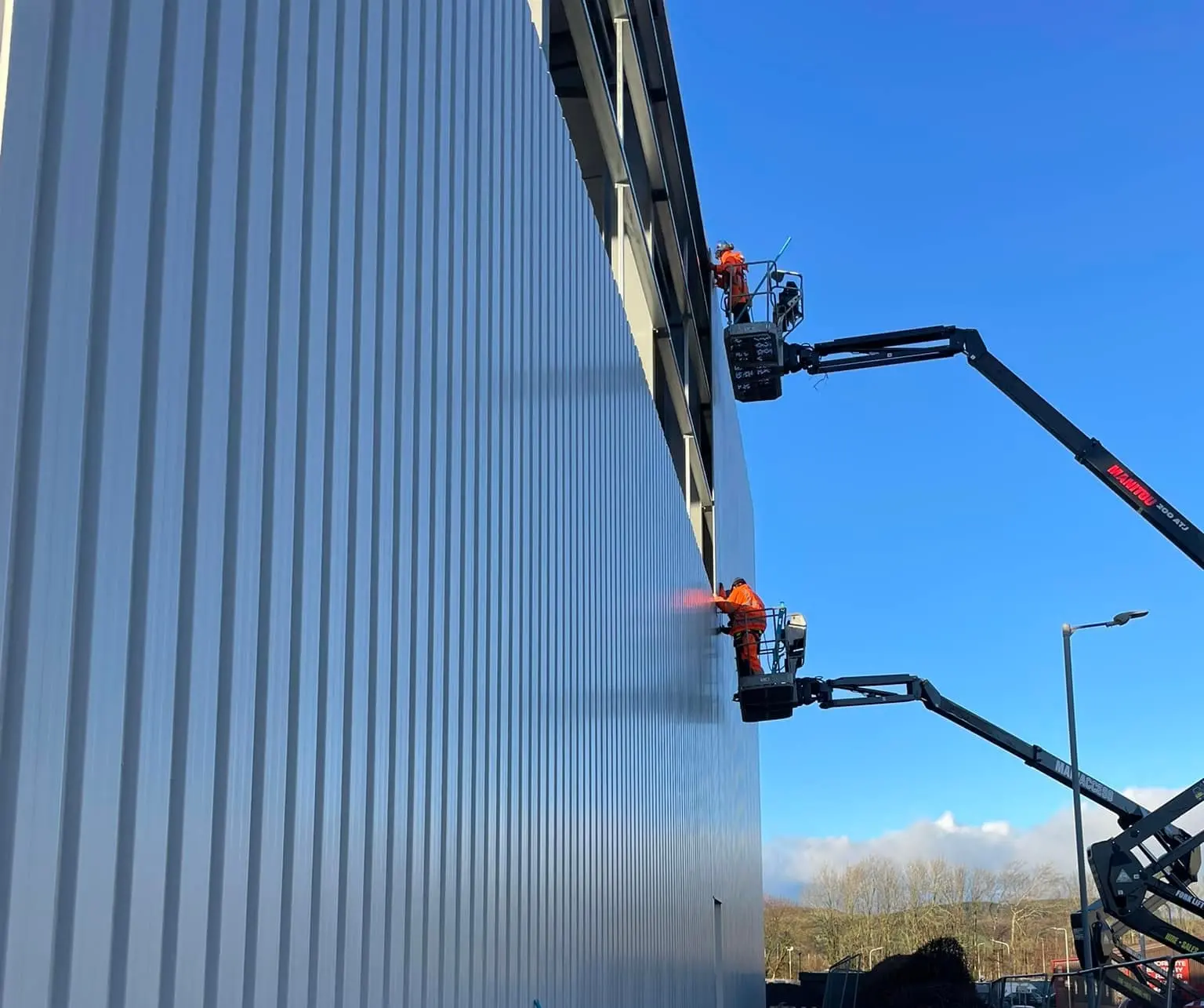 Professional cladding installation on industrial building